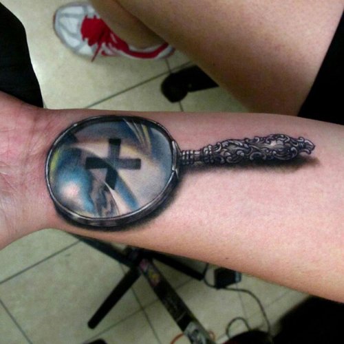 Magnifying Glass Tattoo On Left Forearm