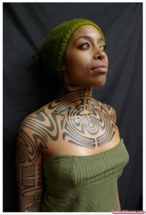 Girl With African Tattoo On Sleeve And Chest