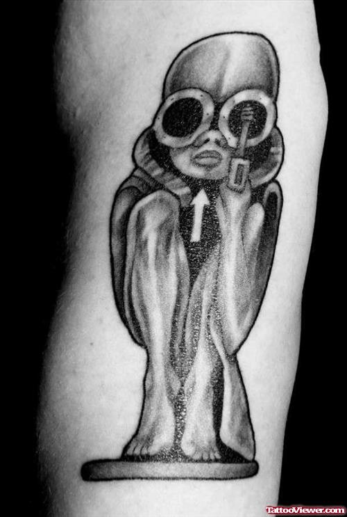 Grey Ink Sitting Alien Tattoo On Bicep