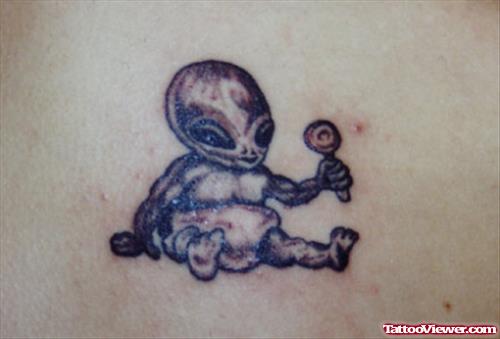 Grey Ink Baby Alien With Lolipop Tattoo