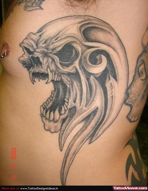 Grey Ink Alien Skull Tattoo On Man Side Rib