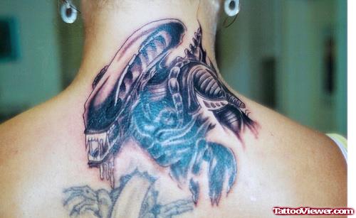 Grey Ink Alien Tattoo On Upperback