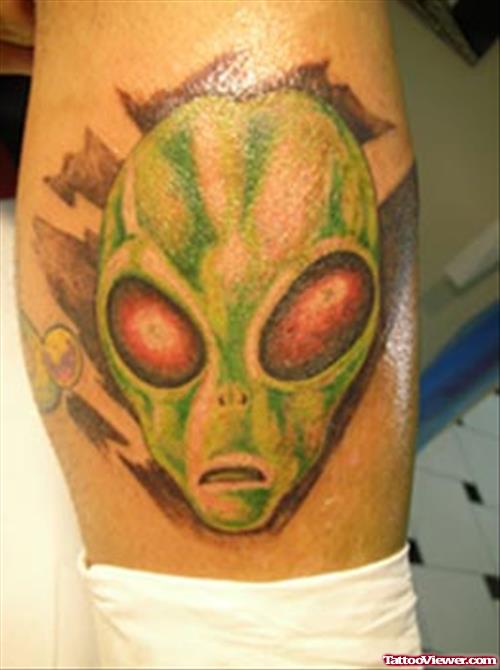 Green Ink Alien Head Tattoo On Leg