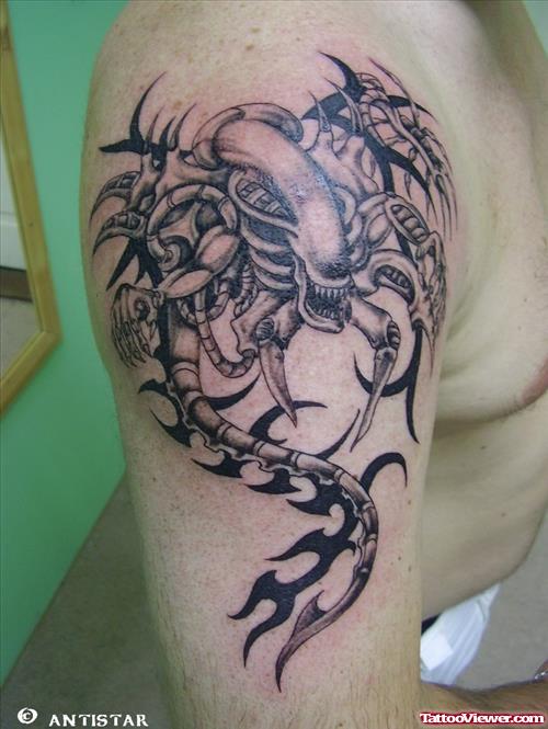 Grey Ink Tribal Alien Tattoo On Right SHoulder