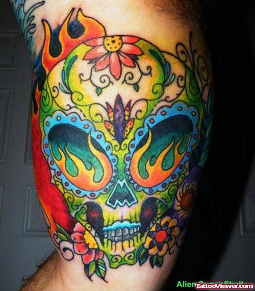 Colored Ink Alien Skull Tattoo On Muscles
