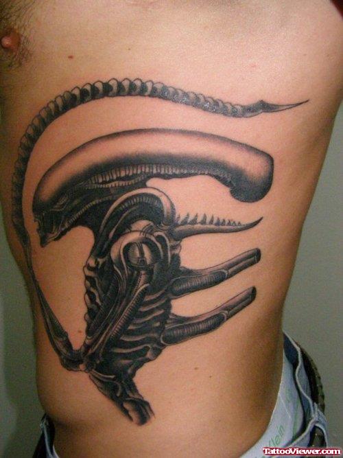 Dark Ink Alien Tattoo On Left Side Rib