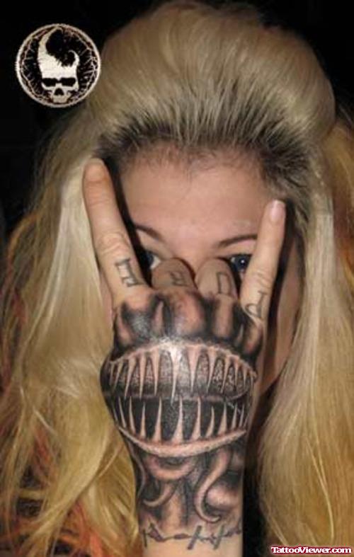 Grey Ink Alien Head Tattoo On Girl Hand