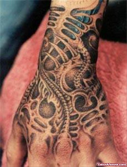 Biomechanical Grey Ink Alien Tattoo On Left Hand