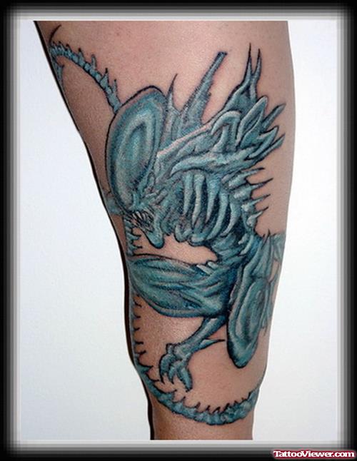 Blue Ink Alien Tattoo On Sleeve