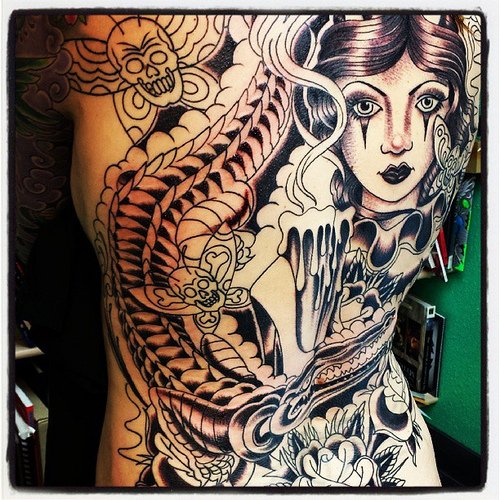 Girl With Flowers And Alligator Tattoo On Back