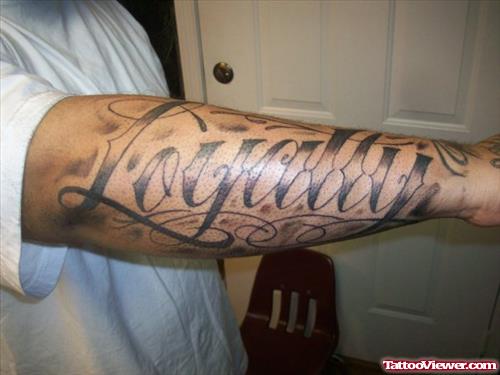Grey Ink Loyalty Ambigram Tattoo On Arm