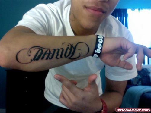Guy showing His Ambigram Family Tattoo