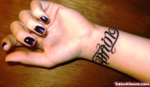 Black Ink Pain Ambigram Tattoo On Left Wrist