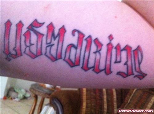 Red Ink Ambigram Tattoo On Bicep