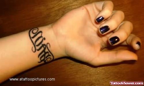 Black Ink Ambigram Tattoo On Girl Right Wrist
