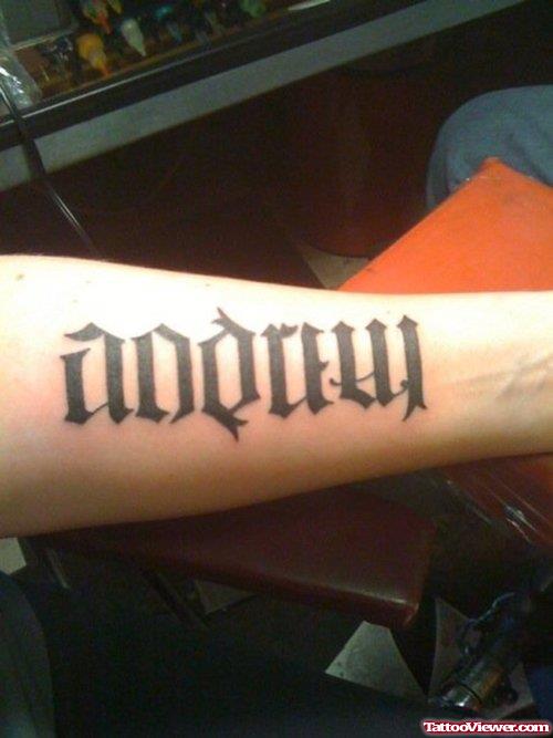 Stylish Black Ink Ambigram Tattoo On Left Arm