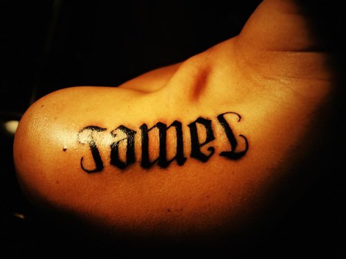 James Ambigram Tattoo On Upper Shoulder