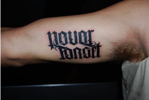 Never Forget Ambigram Tattoo On Muscles
