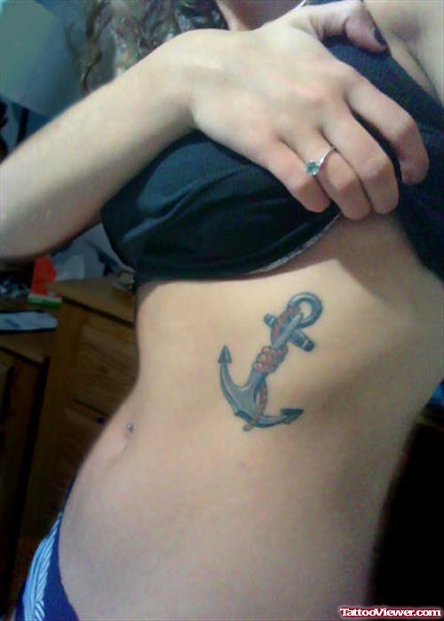 Girl Showing Her Anchor Tattoo On Side Rib