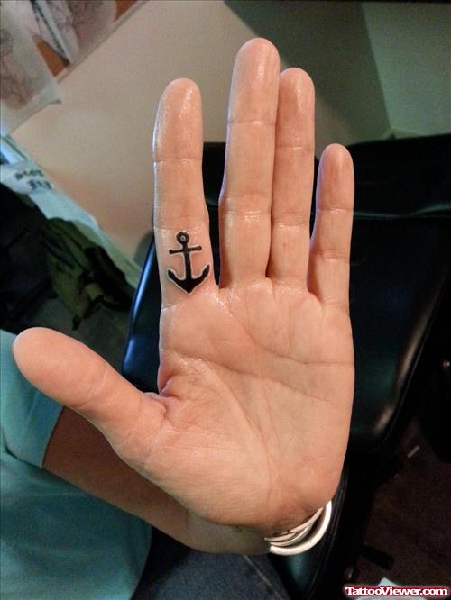 Small Black Anchor Tattoo On Finger