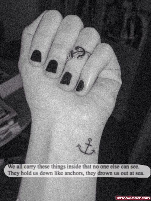 Girl With Anchor Tattoos On Wrist And Finger