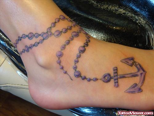 Grey Ink Rosary Anchor Tattoo On Ankle