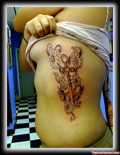 Flowers And Anchor Tattoo On Girl Rib