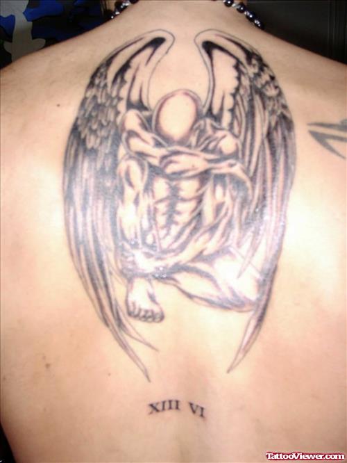 Sad Male Angel Tattoo On Upperback