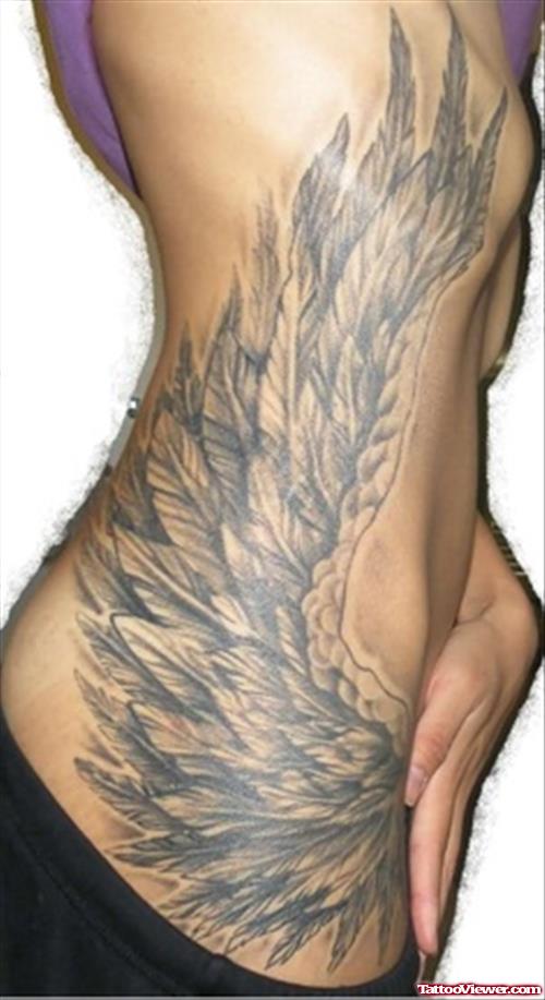 Grey Ink Angel Wing Tattoo On Girl Side Rib