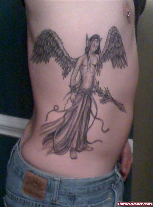 Grey Ink Male Angel With Sword Tattoo On Side Rib