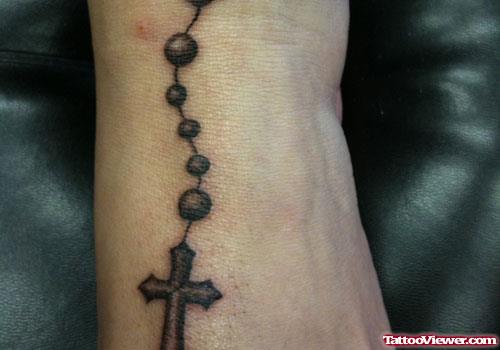 Grey Ink Cross Rosary Ankle Tattoo