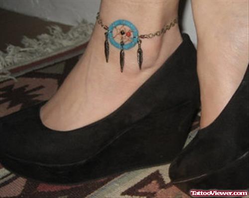Blue Ink Dreamcatcher Tattoo On Left Ankle