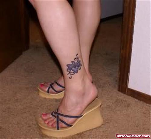 Purple Flower Tattoo On Left Ankle