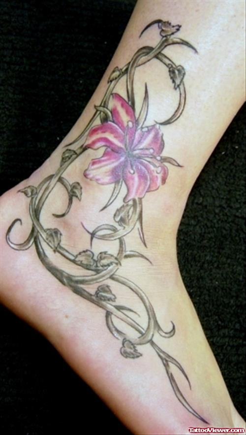 Grey Ink Tribal And Pink Flower Ankle Tattoo