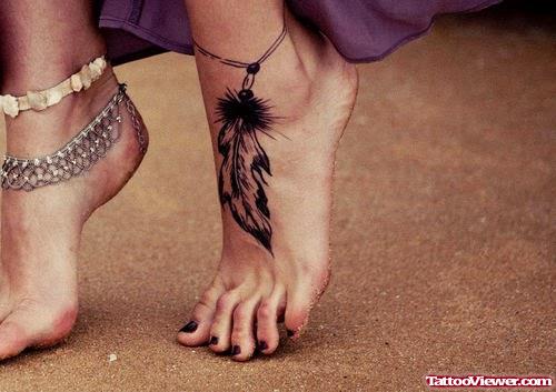 Amazing Black Feather Tattoo On Girl Left Ankle