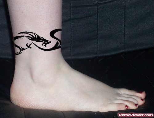 Awesome Black Tribal Dragon Ankle Tattoo