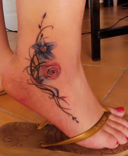 Lovely Tribal Color Flowers Tattoo On Ankle For Girls