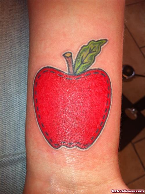 Red Ink Apple Tattoo On Left Sleeve