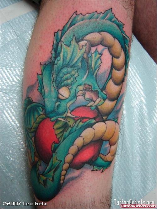 Colored Apple And Snake Tattoo On Right Leg