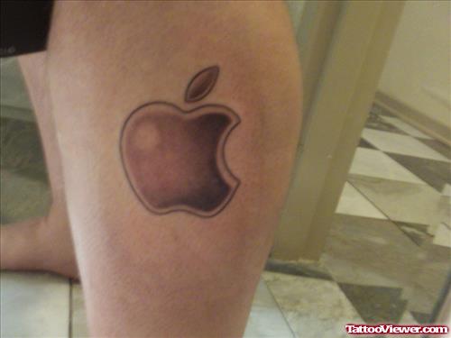 Grey Ink Apple Tattoo On Left Leg