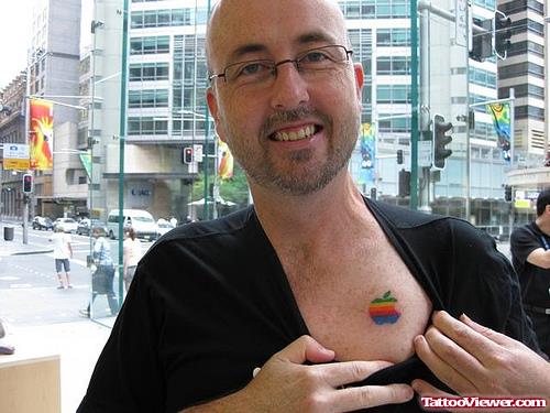 Man showing colorful Apple Tattoo On Chest