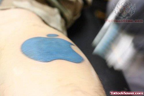Blue Ink Apple Tattoo On Calf