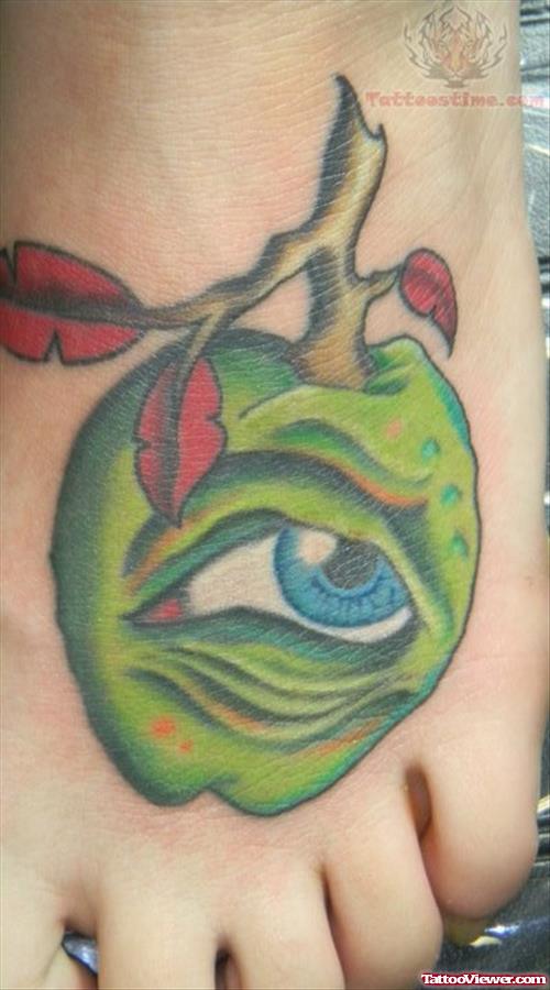 Green Apple And Eye Tattoo On Foot