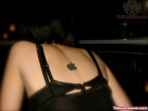 Black Ink Apple Tattoo On Girl Upper Back