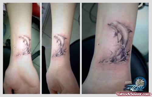 Grey Ink Dolphin Tattoo On Wrist