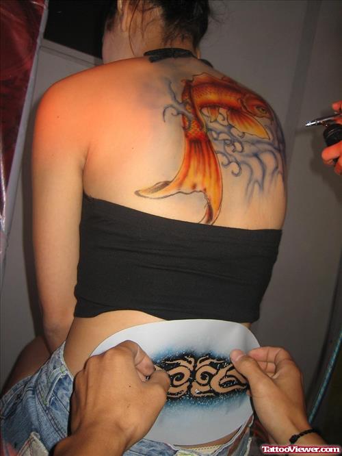 Colored Aqua Tattoo On Girl Upperback