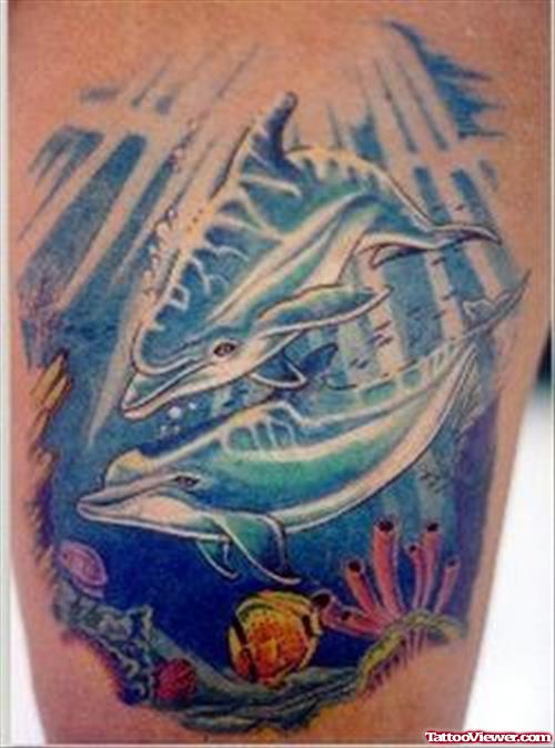 Colored Aqua Dolphin In Ocean Tattoo