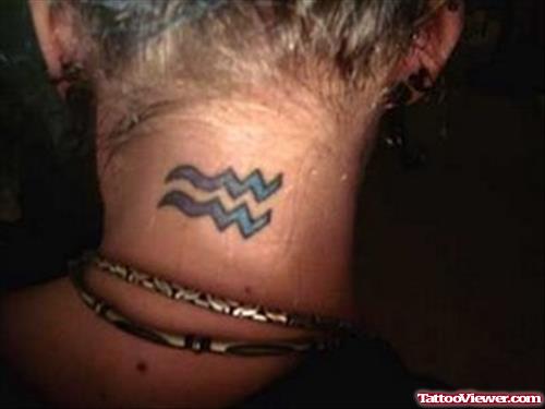 Blue Ink Tribal Aquarius Sun Sign Tattoo On Nape