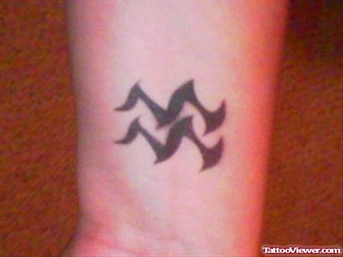 Attractive Black Tribal Aquarius Tattoo On Wrist