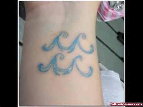 Blue Ink Aquarius Zodiac Tattoo On Wrist
